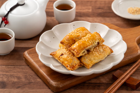 Delicious BBQ pork puff pastry, Char Siu So dim sum food on wooden table background.の写真素材
