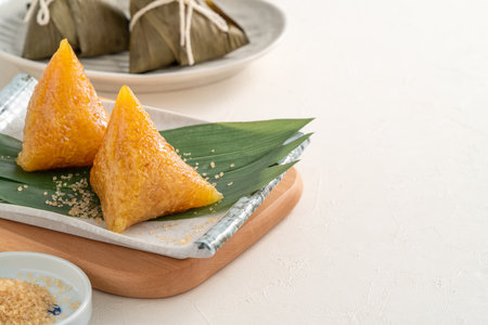 Zongzi, alkaline rice dumpling dessert, Dragon Boat Festival food with honey or sugar.の写真素材