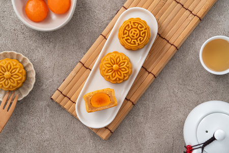 Cantonese moon cake with lotus seed paste and yolk for Mid-Autumn Festival food mooncake on gray...