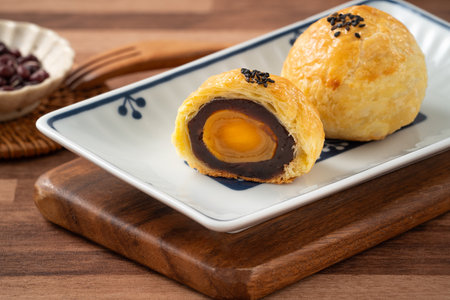 Moon cake yolk pastry, mooncake for Mid-Autumn Festival holiday on wooden table background.