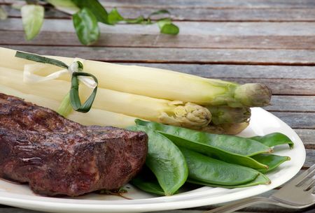 Nice juicy flame grilled Filet Mignon with Asparagus and Snow peaの写真素材