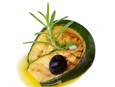 Grilled zucchini rolled up with olive in olive oilの写真素材