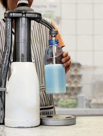 Fresh Bottle Milk from Milkpump in Dairy Farm Shopの写真素材