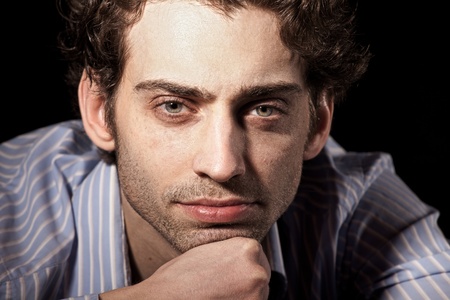 portrait of attractive adult man on black background