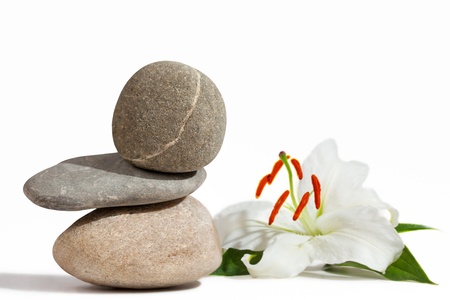 Balancing stones and White Lily, isolated on white background の写真素材
