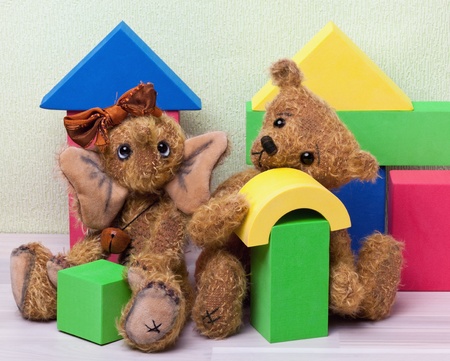 Teddy Bear and Elephant with toy blocks sitting on the Floorの写真素材
