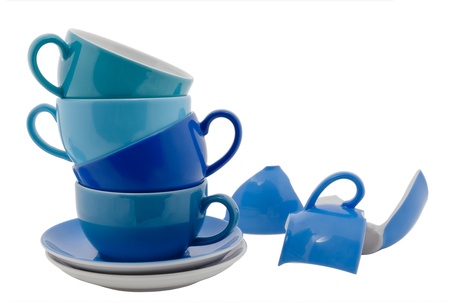 Stack of blue Coffee Cups and one broken cup, isolated on whiteの写真素材