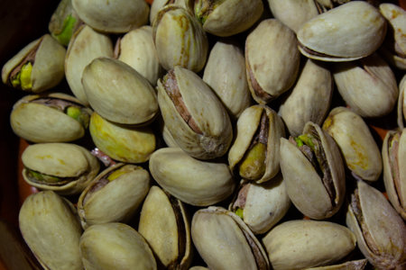 photo close-up a lot of pistachios piled in a pileの写真素材