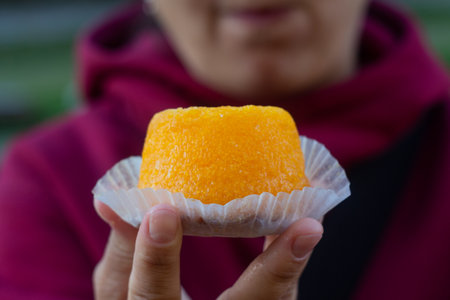 Queijada cake in hand with foreground focusの写真素材