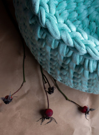 handmade Cotton cord basket on light brown wrapping paper background - top view vertical photo
