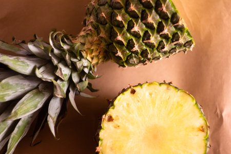 pineapple cut in half crosswise on a light brown backgroundの写真素材