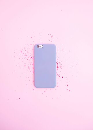 Phone on glitter pink pastel background. Flat layの写真素材