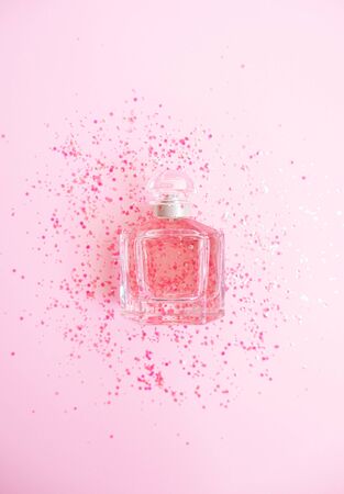 Perfume on glitter pink pastel background. Flat layの写真素材
