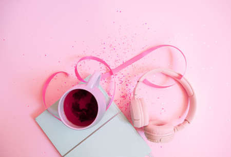 Girl`s pretty pastel set with planner, tea, macaroon and headphones. Flat lay . High quality photoの写真素材