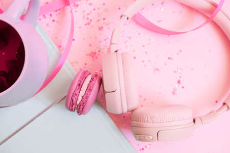 Girls pretty pastel set with planner, tea, macaroon and headphones. Flat lay