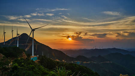 Take pictures of the sunrise over the windmill field on the top of Maofeng Mountain in the early morningの写真素材