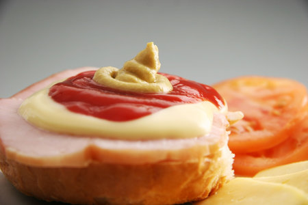 Sandwich with ketchup, mustard and mayonnaise on the top.の写真素材