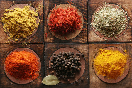 Different tipes of spice on wooden boards.