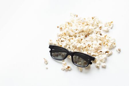 scattered popcorn and 3D glasses on white background. mock up. top view. cinema conceptの写真素材