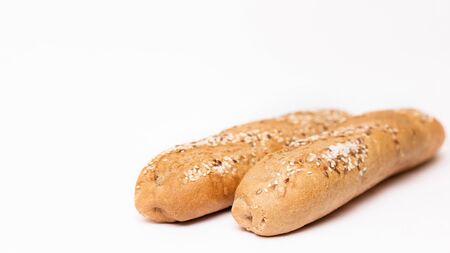 two French baguette with sesame seeds on a white background