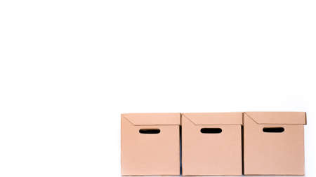 stack of delivery or parcels cardboard boxes on a white background with copy space. shipping and...