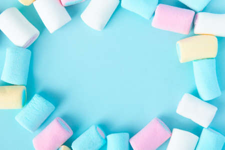 bright multi-colored marshmallows on a blue background