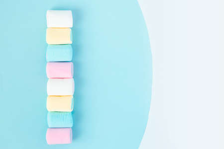 bright multi-colored marshmallows on a blue backgroundの写真素材