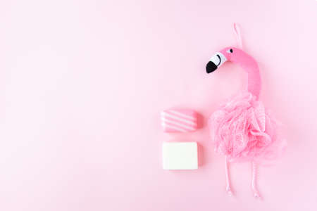 Pink set of soap and washcloth flamingo on pink background. girl body care. bath accessoriesの写真素材
