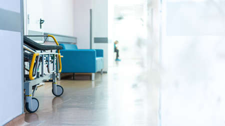 empty hospital corridor with a gurney and a waiting person. medical conceptの写真素材