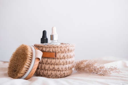 woven jute basket with natural body care products with body brush in bathroom near mirror. Beige interior Natural hygiene products. Zero waste concept.の写真素材