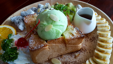 close up honey toasted topping with ice cream and decorate with fruit (banana orange cherry  etc.