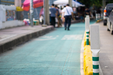 green and white pole on the green road. Milestone concept such as the way we should go forward  step by step like a pole lead to the way we should go for success in every planの写真素材