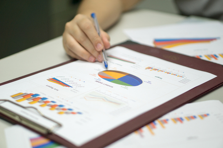 close up business women hands with pen on business document during planning and analysis success plan for company ultimate goal. business conceptの写真素材