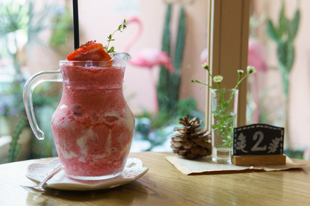 close up of strawberry smoothies with straw in transparent glass.の写真素材