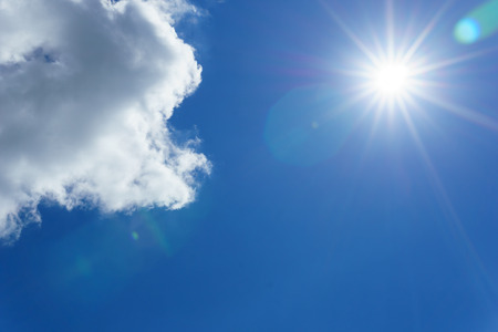 blue sky with clouds and sun for background. sun light shining over the clear sky and clouds....