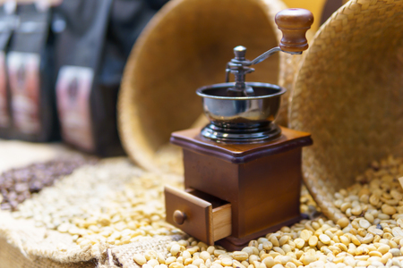 blurred of coffee bean grinder on the pile of coffee beanの写真素材