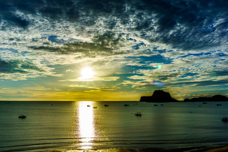 beautiful dramatic sunrise and seascape and skyline with blue sky and fluffy cloud and mountain on the island in the sea with sunshine in the morning. holiday, travel, tourism conceptの写真素材