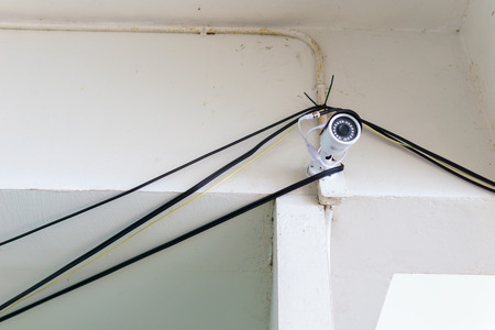 white security cctv camera installed on the wallの写真素材