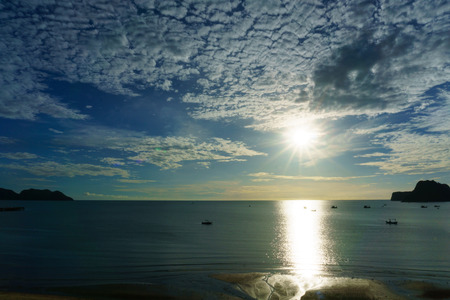 beautiful dramatic beach and seascape and skyline with blue sky and fluffy cloud and mountain on the...