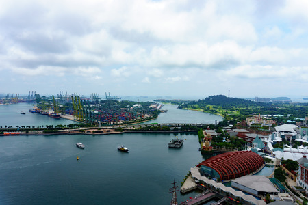 panorama landscape view of commercial port of singapore with cloudy sky. very busy port and important for logistic and transportation in asia. transportation concept.のeditorial素材