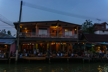 Amphawa,Thailand.December 2,2017. Merchants are selling food on boat at amphawa floating market in the evening.のeditorial素材