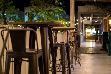 close up stainless steel chair and table on the pathway at night.の写真素材