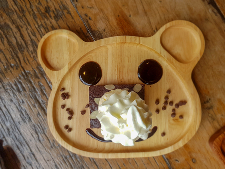 top view of chocolate brownie decoration on the cute wooden plate.の写真素材