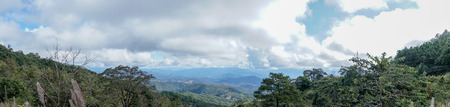 panorama landscape of field with sky and cloud and layer of mountain background