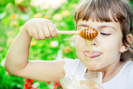 The child eats honey. Selective focus. nature.の写真素材