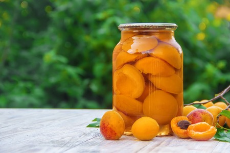 Preserved home-made apricots in jars. Selective focus. Food.の写真素材