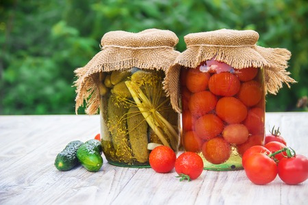 Preserved house tomatoes and cucumbers in cans. Selective focus. Food.の写真素材