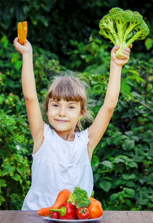child eats vegetables. Summer photo. Selective focus natureの写真素材
