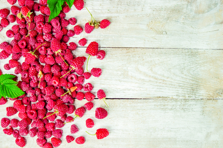 Raspberries on a wooden background. Selective focus. Tea