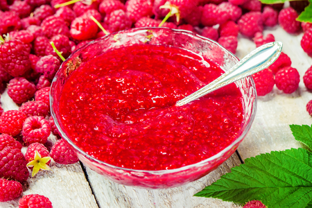 Raspberries on a wooden background. Selective focus. Tea